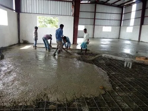 Vacuum dewatered concrete floor being finished in a warehouse